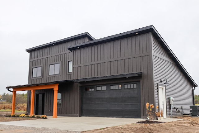2458 Maes Rd, West Branch, MI 48661 - view of front of property with concrete driveway and board and batten siding