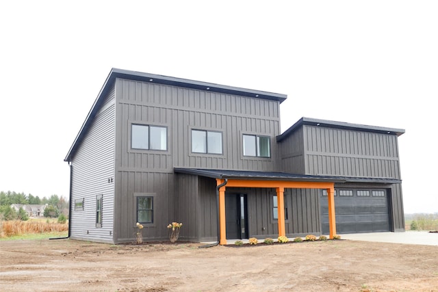 2458 Maes Rd, West Branch, MI 48661 - view of front facade featuring board and batten siding and driveway