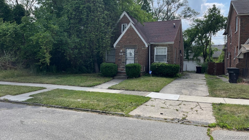 15391 Griggs St, Detroit, MI 48238 - tudor-style house featuring brick siding and concrete driveway