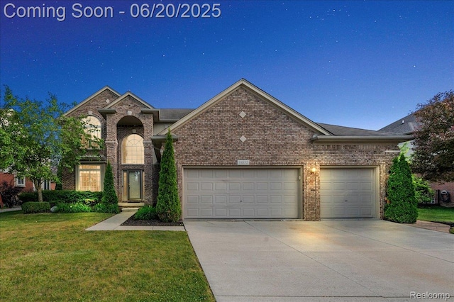 18852 Newbridge Dr, Macomb, MI 48044 - traditional home featuring driveway, a garage, a front yard, and brick siding