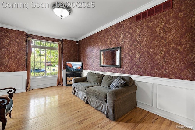 18852 Newbridge Dr, Macomb, MI 48044 - living area with wallpapered walls, a wainscoted wall, hardwood / wood-style flooring, and crown molding