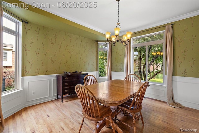 18852 Newbridge Dr, Macomb, MI 48044 - dining room with a chandelier, a wainscoted wall, light wood-style flooring, wallpapered walls, and crown molding