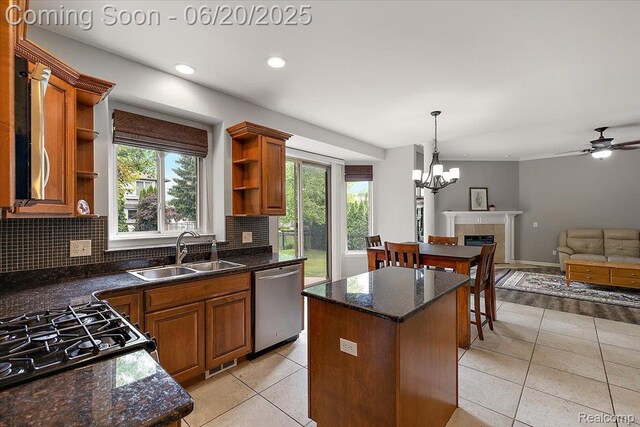 18852 Newbridge Dr, Macomb, MI 48044 - kitchen with stainless steel dishwasher, open shelves, light tile patterned floors, a center island, and backsplash