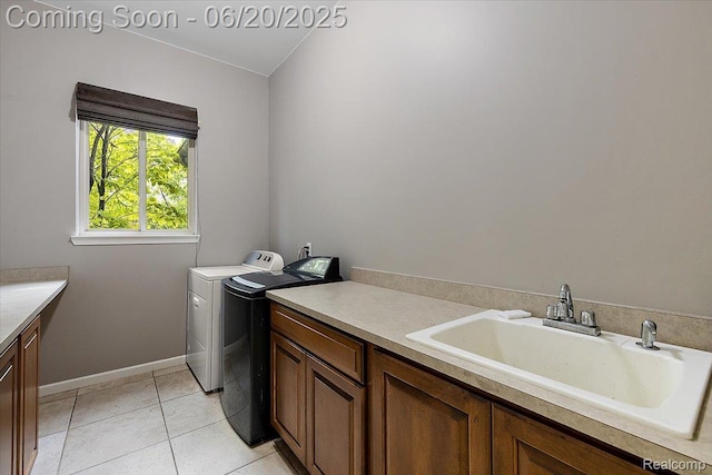 18852 Newbridge Dr, Macomb, MI 48044 - washroom featuring washing machine and clothes dryer, cabinet space, and light tile patterned floors