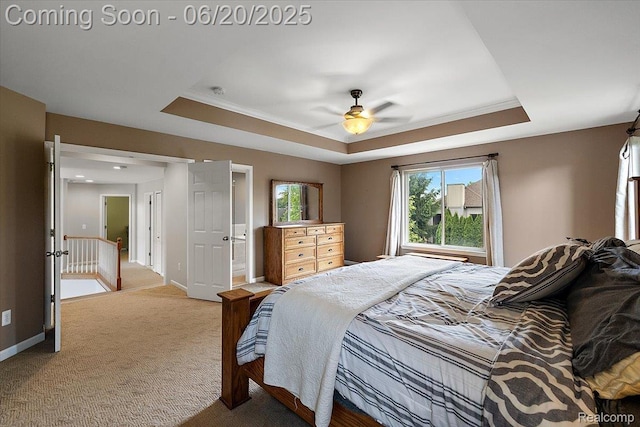 18852 Newbridge Dr, Macomb, MI 48044 - carpeted bedroom featuring a tray ceiling, ornamental molding, connected bathroom, and a ceiling fan