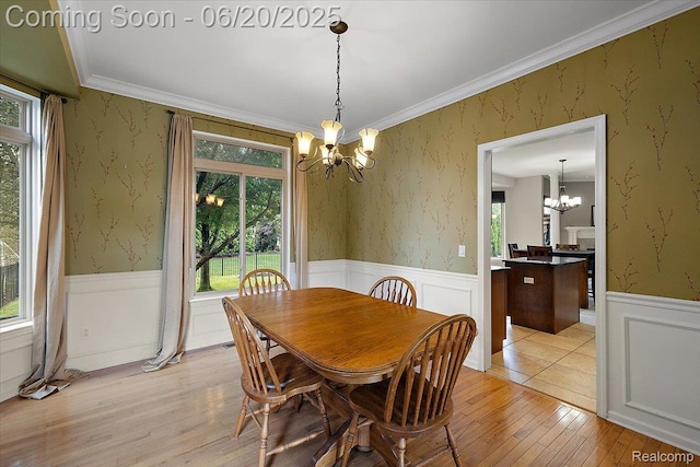 18852 Newbridge Dr, Macomb, MI 48044 - dining area with a chandelier, plenty of natural light, a wainscoted wall, light wood-style flooring, and crown molding