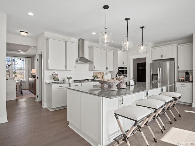 24654 Floret, Macomb, MI 48042 - kitchen featuring wall chimney exhaust hood, appliances with stainless steel finishes, tasteful backsplash, white cabinetry, and recessed lighting