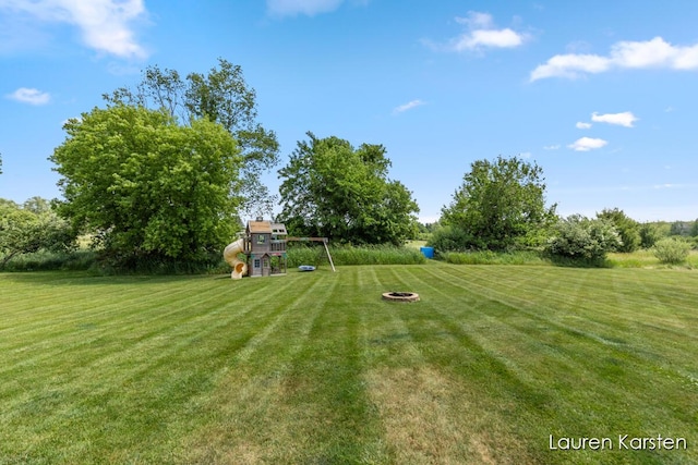 14734 Crescent Meadows Dr, Cedar Springs, MI 49319 - view of green lawn featuring a playground and a fire pit
