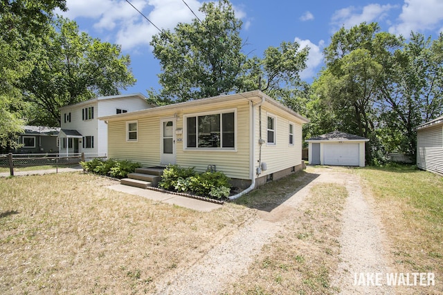 1428 Matilda St NE, Grand Rapids, MI 49503 - view of front of property featuring an outbuilding, dirt driveway, and a detached garage