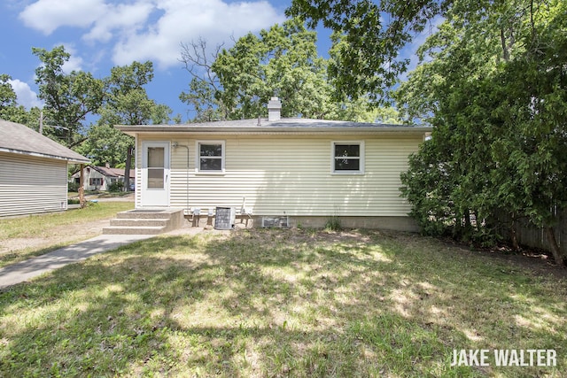1428 Matilda St NE, Grand Rapids, MI 49503 - rear view of property featuring a yard and a chimney