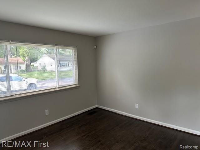 34940 John St, Wayne, MI 48184 - empty room with dark wood-type flooring and baseboards