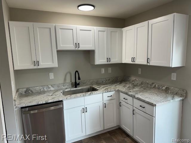 34940 John St, Wayne, MI 48184 - kitchen with dishwasher, white cabinetry, and light stone countertops