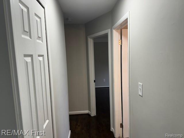 34940 John St, Wayne, MI 48184 - hallway with baseboards and dark wood-style flooring