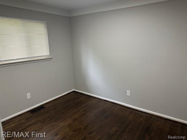 34940 John St, Wayne, MI 48184 - spare room featuring baseboards and dark wood-style flooring