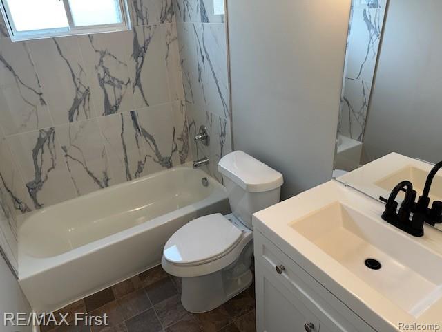 34940 John St, Wayne, MI 48184 - full bathroom featuring vanity, shower / bath combination, and stone finish floors
