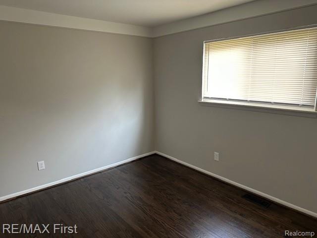 34940 John St, Wayne, MI 48184 - empty room with baseboards and dark wood-type flooring
