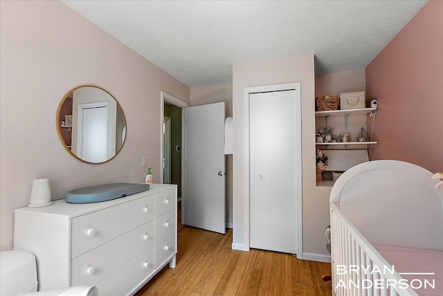 1910 Hall St SE, Grand Rapids, MI 49506 - bedroom featuring light wood finished floors, a closet, and a textured ceiling