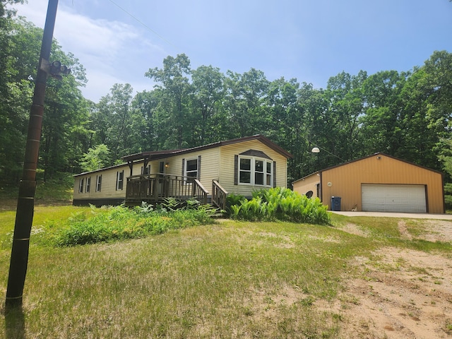 1593 W Centerline Rd, Baldwin, MI 49304 - manufactured / mobile home with a detached garage, a deck, an outbuilding, and a front lawn