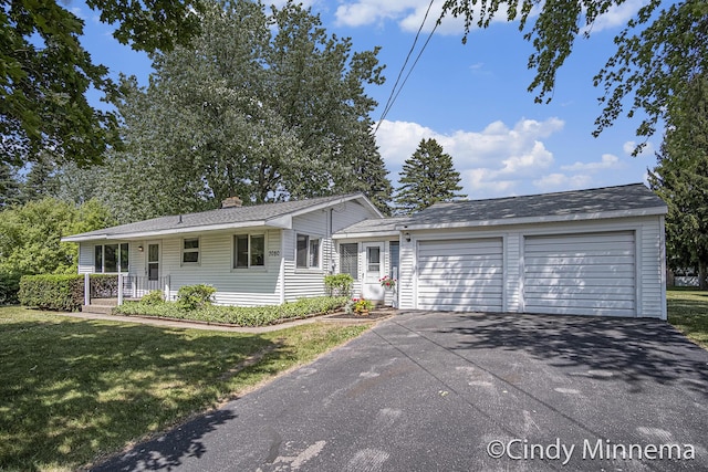 7080 Pine Island Dr NE, Comstock Park, MI 49321 - single story home featuring a front yard, a chimney, a garage, and driveway