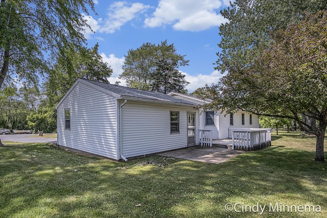 7080 Pine Island Dr NE, Comstock Park, MI 49321 - back of property with a yard, a wooden deck, and a patio area