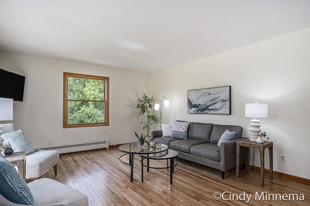7080 Pine Island Dr NE, Comstock Park, MI 49321 - living area with a baseboard radiator and wood finished floors