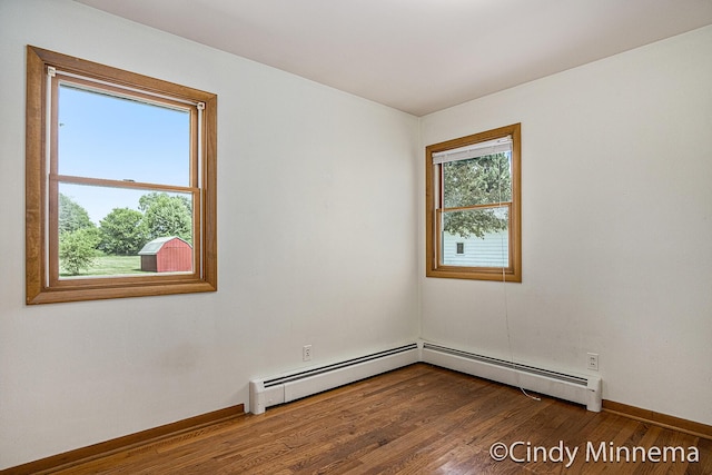 7080 Pine Island Dr NE, Comstock Park, MI 49321 - empty room featuring wood finished floors and a baseboard radiator