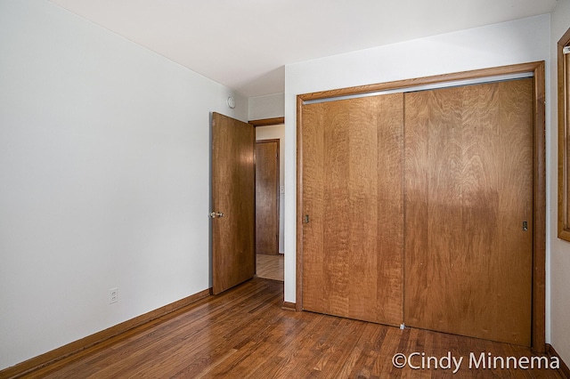 7080 Pine Island Dr NE, Comstock Park, MI 49321 - unfurnished bedroom featuring wood finished floors and a closet