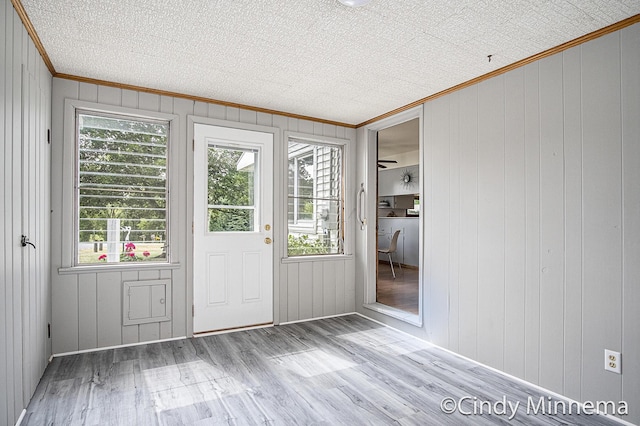 7080 Pine Island Dr NE, Comstock Park, MI 49321 - entryway with ornamental molding, wood finished floors, and wood walls