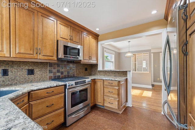 32203 Anita Dr, Westland, MI 48185 - kitchen with stainless steel appliances, brown cabinetry, tasteful backsplash, a peninsula, and light stone countertops