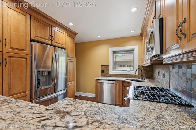 32203 Anita Dr, Westland, MI 48185 - kitchen with stainless steel appliances, light stone countertops, brown cabinetry, tasteful backsplash, and recessed lighting