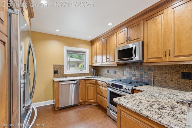 32203 Anita Dr, Westland, MI 48185 - kitchen with stainless steel appliances, light stone countertops, tasteful backsplash, brown cabinetry, and recessed lighting