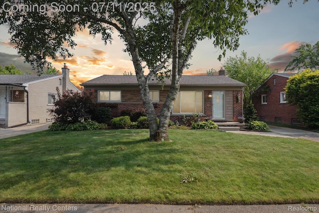 32203 Anita Dr, Westland, MI 48185 - view of front facade featuring brick siding, a chimney, and a lawn