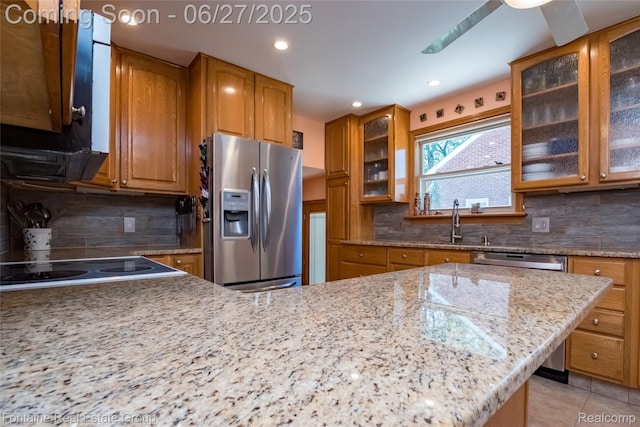 21626 Oconnor St, Saint Clair Shores, MI 48080 - kitchen featuring appliances with stainless steel finishes, brown cabinetry, decorative backsplash, light stone counters, and recessed lighting