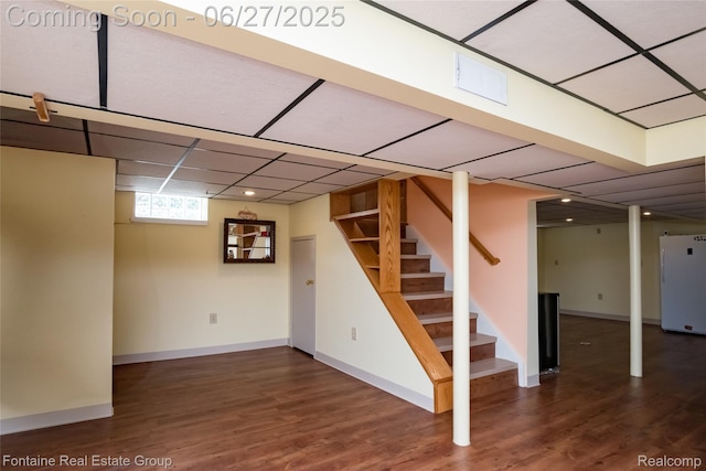 21626 Oconnor St, Saint Clair Shores, MI 48080 - basement featuring freestanding refrigerator, a paneled ceiling, wood finished floors, and stairs