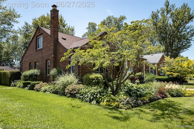 21626 Oconnor St, Saint Clair Shores, MI 48080 - view of property exterior with a lawn, brick siding, a chimney, and a shingled roof