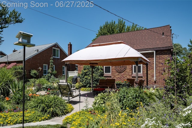 21626 Oconnor St, Saint Clair Shores, MI 48080 - back of house featuring a gazebo, brick siding, a patio area, an outdoor living space, and a shingled roof