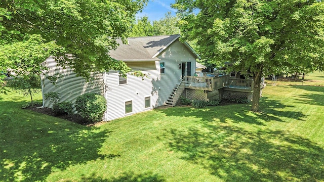 3700 Mapledge Ct NE, Cedar Springs, MI 49319 - view of home's exterior with a wooden deck, a yard, stairs, and roof with shingles