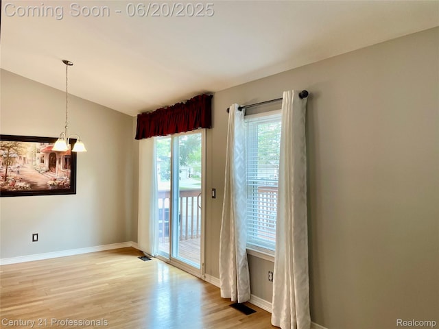 6850 Deerhurst Dr, Westland, MI 48185 - unfurnished dining area featuring light wood finished floors and a chandelier