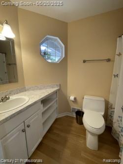 6850 Deerhurst Dr, Westland, MI 48185 - bathroom with vanity, wood finished floors, and curtained shower
