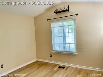 6850 Deerhurst Dr, Westland, MI 48185 - unfurnished room featuring wood finished floors and vaulted ceiling