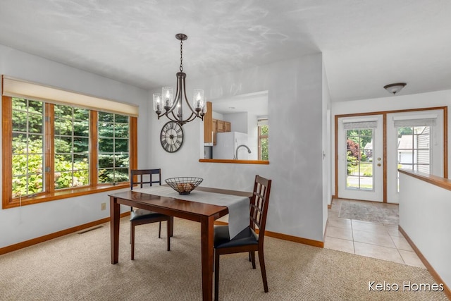 766 Clarewood Ct, Holland, MI 49423 - dining space with a chandelier, healthy amount of natural light, light carpet, and light tile patterned floors