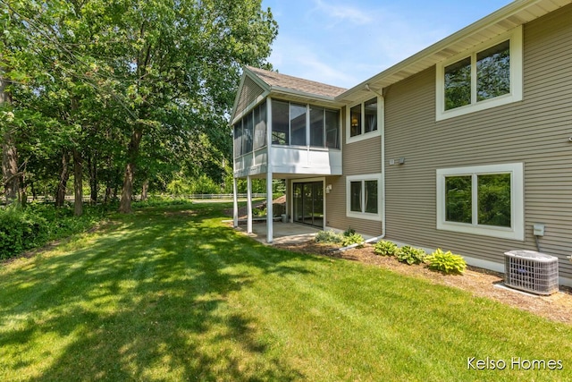 766 Clarewood Ct, Holland, MI 49423 - rear view of house featuring a sunroom, a yard, and a patio