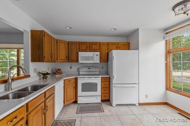 766 Clarewood Ct, Holland, MI 49423 - kitchen featuring white appliances, light countertops, brown cabinetry, and light tile patterned floors