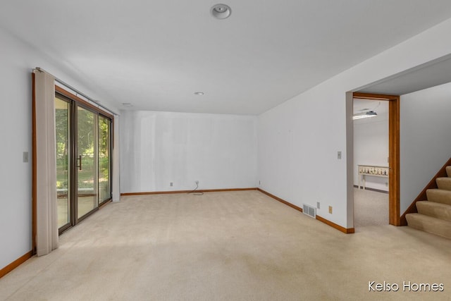 766 Clarewood Ct, Holland, MI 49423 - unfurnished living room with light colored carpet and stairway