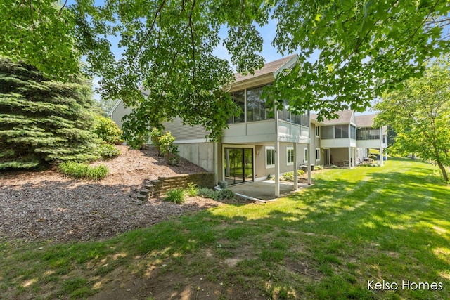 766 Clarewood Ct, Holland, MI 49423 - rear view of property featuring a sunroom, a patio area, and a yard