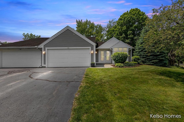 766 Clarewood Ct, Holland, MI 49423 - single story home featuring a lawn, french doors, asphalt driveway, and a garage