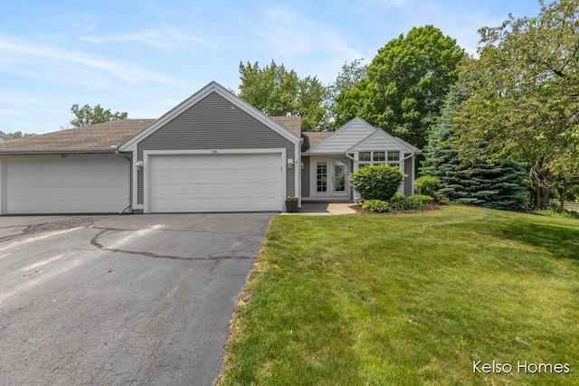 766 Clarewood Ct, Holland, MI 49423 - single story home featuring asphalt driveway, an attached garage, a front lawn, and french doors