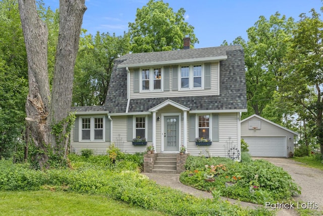 140 Lakeside Dr NE, Grand Rapids, MI 49503 - colonial inspired home featuring an outbuilding, a garage, a chimney, and a shingled roof