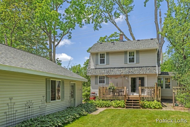 140 Lakeside Dr NE, Grand Rapids, MI 49503 - back of property featuring a deck, a yard, a shingled roof, and a chimney