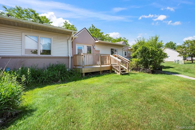 29680 Olympia Ct, Farmington Hills, MI 48336 - rear view of property with a wooden deck, brick siding, and a lawn